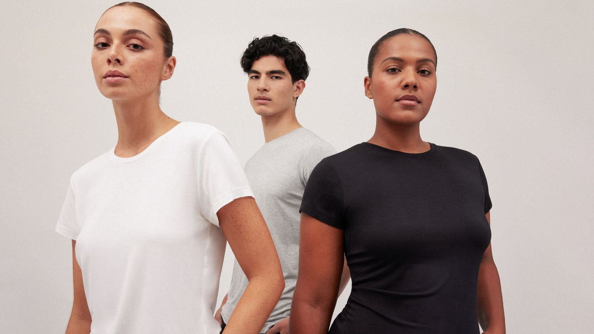 Three models wearing casual bamboo T-shirts in white, grey and black.