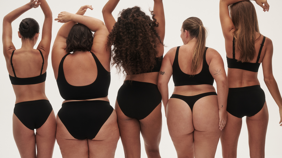 Five women wearing black bras and underwear in a range of styles and fits.